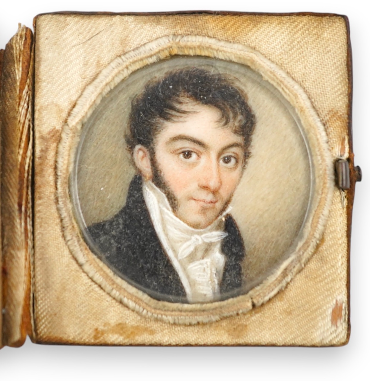 A mid 19th century French portrait miniature of a gentleman on ivory, in leather case inscribed 'Souvenir', 4.3cm high overall. CITES Submission reference V6R44LRJ. Condition - fair to good.